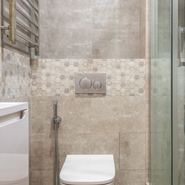 Concealed shower valve behind a glass screen